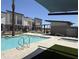 An inviting community pool, showcasing the pool, palm trees, and nearby buildings at 651 N Ironwood Dr # 3, Apache Junction, AZ 85120
