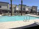 A clean community pool with palm trees and nearby buildings, offering a refreshing outdoor experience at 651 N Ironwood Dr # 3, Apache Junction, AZ 85120