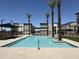 A community pool with clear water, palm trees, and grilling area at 651 N Ironwood Dr # 3, Apache Junction, AZ 85120