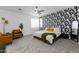 Modern bedroom with patterned wallpaper, ceiling fan, carpet and leather chairs at 651 N Ironwood Dr # 4, Apache Junction, AZ 85120