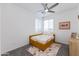 Bedroom with neutral carpet, ceiling fan, natural light, and a bed with decorative pillows and accessories at 651 N Ironwood Dr # 4, Apache Junction, AZ 85120
