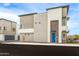 Modern townhome exterior with varying textures and a blue front door at 651 N Ironwood Dr # 4, Apache Junction, AZ 85120