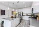 Bright kitchen features white cabinets, stainless appliances, light grey countertop and island with sink at 651 N Ironwood Dr # 4, Apache Junction, AZ 85120