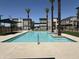 Community pool with mature palms offers a resort-style living experience at 651 N Ironwood Dr # 4, Apache Junction, AZ 85120