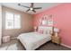 Charming bedroom featuring pink patterned wallpaper, plush pillows, and natural light at 651 N Ironwood Dr # 7, Apache Junction, AZ 85120