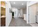 Open hallway leading to a well-lit area, with doorways to various rooms and a decorative plant at 651 N Ironwood Dr # 7, Apache Junction, AZ 85120