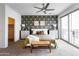 Inviting main bedroom with patterned accent wall, ceiling fan, and access to a balcony at 651 N Ironwood Dr # 7, Apache Junction, AZ 85120