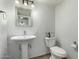 Cozy bathroom with pedestal sink, updated fixtures, a modern mirror, and neutral paint at 7126 N 19Th Ave # 165, Phoenix, AZ 85021