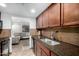 Modern kitchen with dark cabinets, stainless steel sink, and views to the living area at 7126 N 19Th Ave # 165, Phoenix, AZ 85021