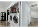 Laundry room with a washer and dryer and shelves filled with storage items at 7126 N 19Th Ave # 165, Phoenix, AZ 85021