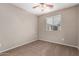 Cozy bedroom with neutral walls, ceiling fan, and a window, offering a comfortable retreat at 7172 S 48Th Gln, Laveen, AZ 85339