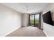 Bright bedroom with balcony access, carpeted floors, and natural light at 7175 E Camelback Rd # 307, Scottsdale, AZ 85251