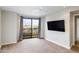 Bright bedroom with flat screen TV and balcony access at 7175 E Camelback Rd # 307, Scottsdale, AZ 85251