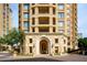 Beautiful facade of building entrance with stone detail, arched doorway, and manicured landscaping at 7175 E Camelback Rd # 307, Scottsdale, AZ 85251