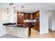 Stylish kitchen with dark wood cabinets, stainless appliances, and a breakfast bar at 7175 E Camelback Rd # 307, Scottsdale, AZ 85251