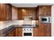 Kitchen area showcasing dark wood cabinetry and stainless steel appliances at 7175 E Camelback Rd # 307, Scottsdale, AZ 85251