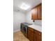 Modern laundry room with front loading washer and dryer, plus countertop and cabinet storage at 7175 E Camelback Rd # 307, Scottsdale, AZ 85251