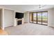 Open living room with fireplace, flat screen tv, and sliding doors to balcony at 7175 E Camelback Rd # 307, Scottsdale, AZ 85251