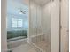 Modern bathroom featuring a glass-enclosed shower with bench and tiled walls, connecting to the bedroom at 778 E Harper St # 101, Gilbert, AZ 85297