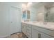 Bright bathroom with double sink vanity, modern fixtures, and a glass-enclosed shower at 778 E Harper St # 101, Gilbert, AZ 85297