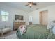 Bright bedroom featuring modern decor, a stylish dresser with television, and a view into the bathroom at 778 E Harper St # 101, Gilbert, AZ 85297