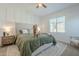 Bright bedroom with a large bed, decorative pillows, side tables, and a neutral color palette with an adorable dog at 778 E Harper St # 101, Gilbert, AZ 85297