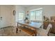 Cozy dining room with a rustic wooden table, bench seating, and modern decor. Abundant natural light fills the space at 778 E Harper St # 101, Gilbert, AZ 85297