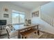 Inviting dining room featuring a wooden table with bench seating and chairs, complemented by natural light from a large window at 778 E Harper St # 101, Gilbert, AZ 85297
