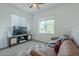 Cozy living room with plush leather couch, stylish rug, and a media center with TV at 778 E Harper St # 101, Gilbert, AZ 85297