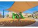 Community playground featuring shade, multiple slides, and woodchips at 778 E Harper St # 101, Gilbert, AZ 85297