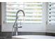 A close-up of the soaking tub in the main bathroom and the window with the shutter at 7878 E Gainey Ranch Rd # 57, Scottsdale, AZ 85258