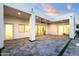 Expansive patio with stylish pavers, opening to a bright, modern interior and landscaped yard at 8713 N 80Th Pl, Scottsdale, AZ 85258