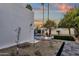 Contemporary home design with yard showcasing gravel, pavers and grass surrounded by palms at 8713 N 80Th Pl, Scottsdale, AZ 85258