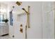 Close up of gold showerhead with glass and textured wall at 8713 N 80Th Pl, Scottsdale, AZ 85258