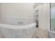 Bathroom with soaking tub, glass shower, and walk-in closet at 8713 N 80Th Pl, Scottsdale, AZ 85258