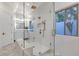 Glass walk-in shower with a gold rainfall showerhead, with a built-in bench at 8713 N 80Th Pl, Scottsdale, AZ 85258