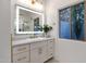 Bathroom vanity with LED mirror, gold fixtures, and accent plant at 8713 N 80Th Pl, Scottsdale, AZ 85258