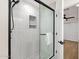 Elegant shower with white marble tile, a stylish niche, and a sleek glass door at 8713 N 80Th Pl, Scottsdale, AZ 85258