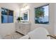 Bright bathroom with double windows, soaking tub, and vanity at 8713 N 80Th Pl, Scottsdale, AZ 85258