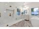 Bright bathroom with gold fixtures, soaking tub, shower, herringbone tile, and modern vanity mirror at 8713 N 80Th Pl, Scottsdale, AZ 85258
