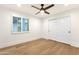 An empty bedroom featuring hardwood floors, a ceiling fan, and a closet with sliding doors at 8713 N 80Th Pl, Scottsdale, AZ 85258