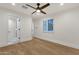 Bedroom with hardwood floors, ceiling fan, and an ensuite bathroom at 8713 N 80Th Pl, Scottsdale, AZ 85258