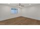 Bright bedroom with shuttered windows, hardwood floors, and ample space for a comfortable living environment at 8713 N 80Th Pl, Scottsdale, AZ 85258