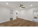 Airy bedroom with beautiful hardwood floors, a ceiling fan, and access to an ensuite bathroom and walk-in closet at 8713 N 80Th Pl, Scottsdale, AZ 85258