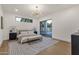 Bright bedroom features a large window, sliding glass door to backyard, and a patterned gray rug at 8713 N 80Th Pl, Scottsdale, AZ 85258