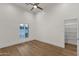 Bright bedroom with a large window, hardwood floors, and a spacious walk-in closet at 8713 N 80Th Pl, Scottsdale, AZ 85258