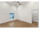 An airy bedroom featuring hardwood floors, ample natural light, and a closet with shelving at 8713 N 80Th Pl, Scottsdale, AZ 85258