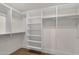 Custom walk-in closet features ample shelving and hanging rods for optimal storage in this stunning home at 8713 N 80Th Pl, Scottsdale, AZ 85258