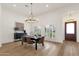 Bright dining room with hardwood floors, vaulted ceilings, and plantation shutters at 8713 N 80Th Pl, Scottsdale, AZ 85258