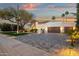 Elegant home with a paver driveway, manicured landscaping, and a spacious three-car garage at 8713 N 80Th Pl, Scottsdale, AZ 85258